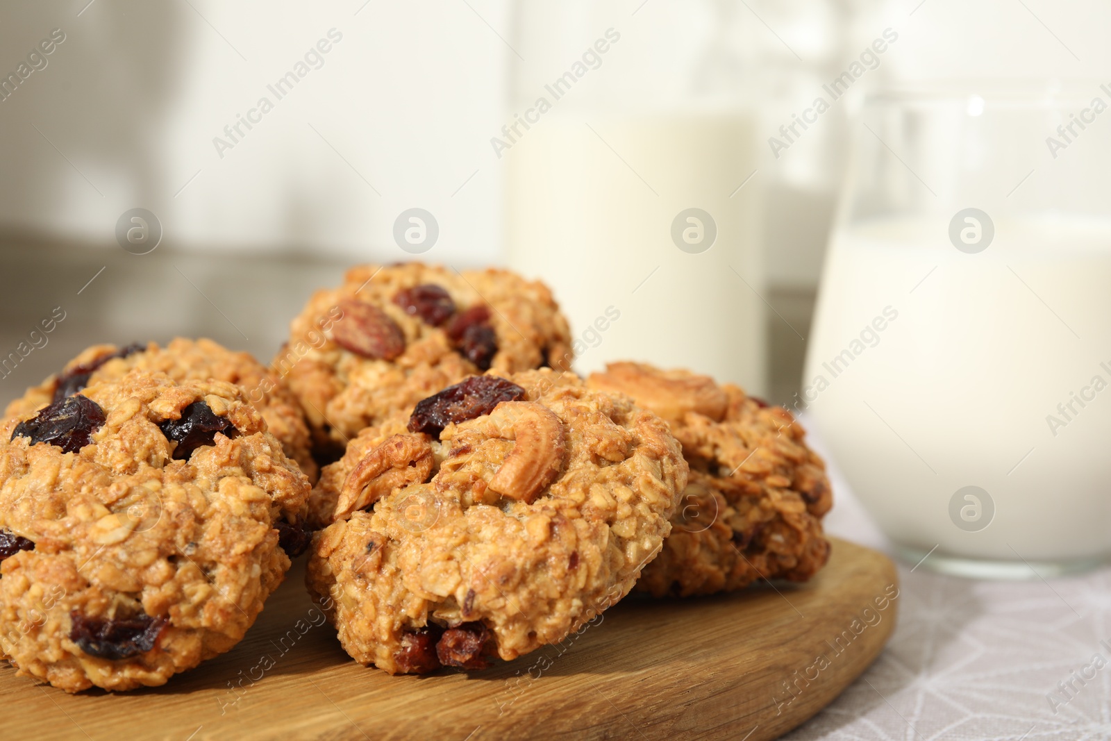 Photo of Delicious oatmeal cookies with raisins and nuts on table, closeup