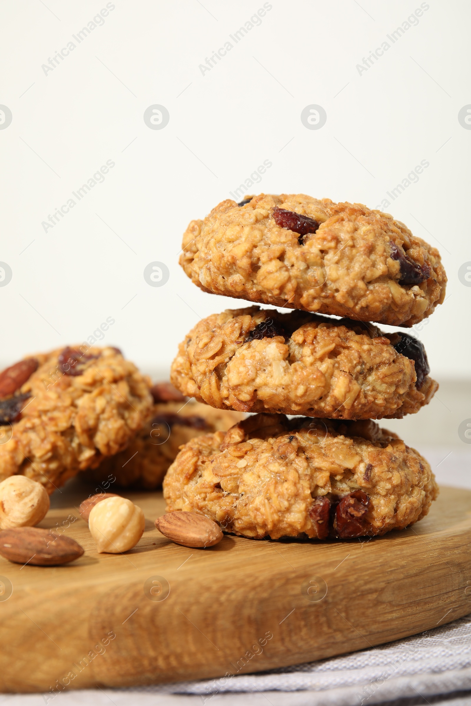 Photo of Delicious oatmeal cookies with raisins and nuts on table, closeup