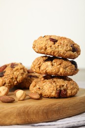 Delicious oatmeal cookies with raisins and nuts on table, closeup