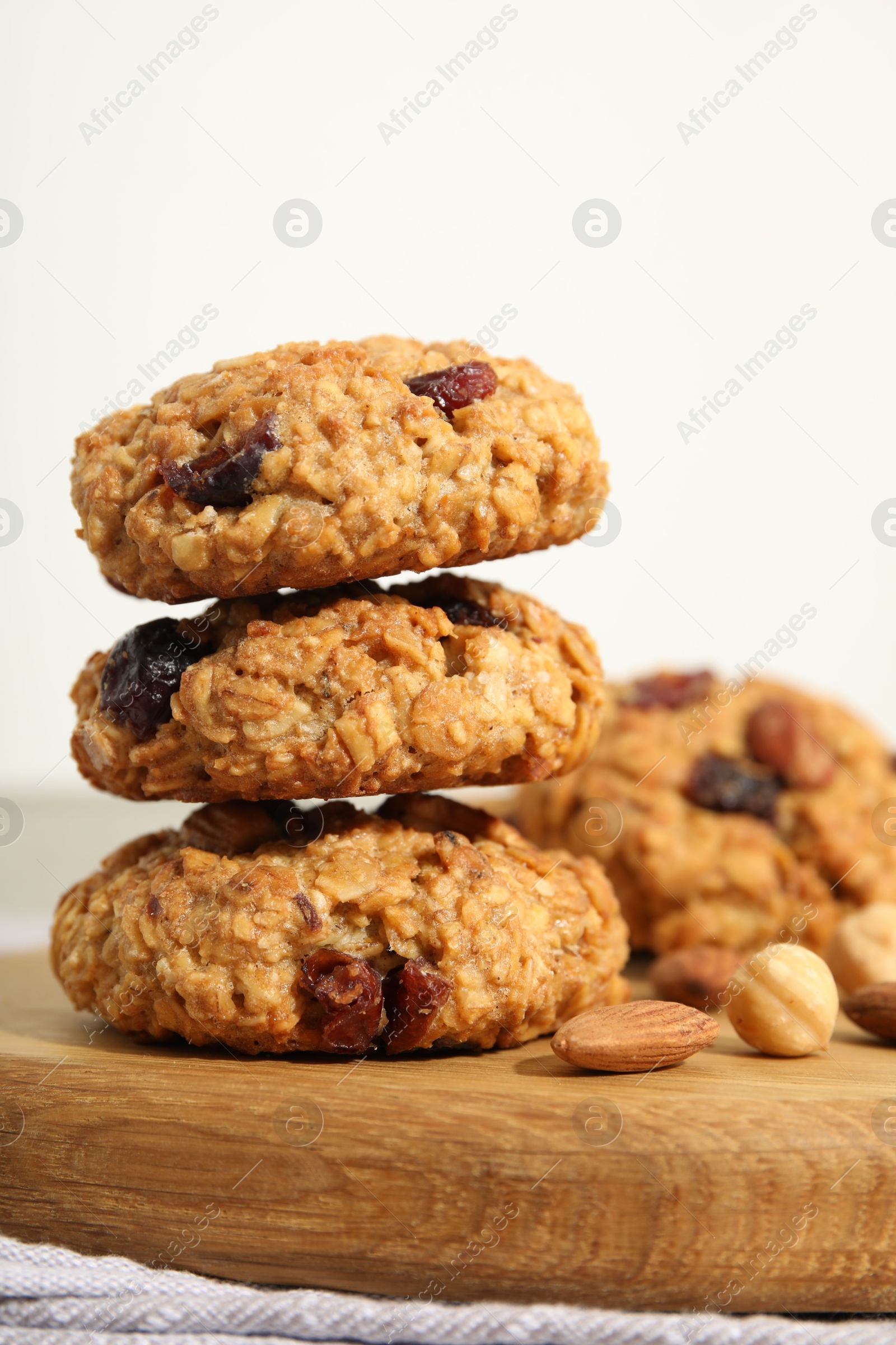 Photo of Delicious oatmeal cookies with raisins and nuts on table, closeup