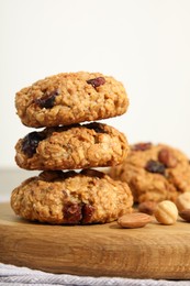 Photo of Delicious oatmeal cookies with raisins and nuts on table, closeup