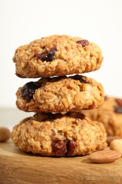 Delicious oatmeal cookies with raisins and nuts on table, closeup