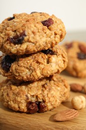 Photo of Delicious oatmeal cookies with raisins and nuts on table, closeup