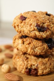 Photo of Delicious oatmeal cookies with raisins and nuts on table, closeup