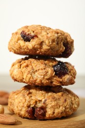 Photo of Delicious oatmeal cookies with raisins and nuts on table, closeup