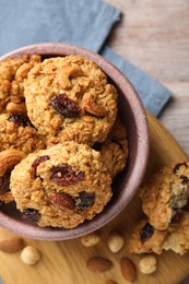 Photo of Delicious oatmeal cookies with raisins and nuts on table, top view