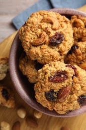 Photo of Delicious oatmeal cookies with raisins and nuts on table, top view