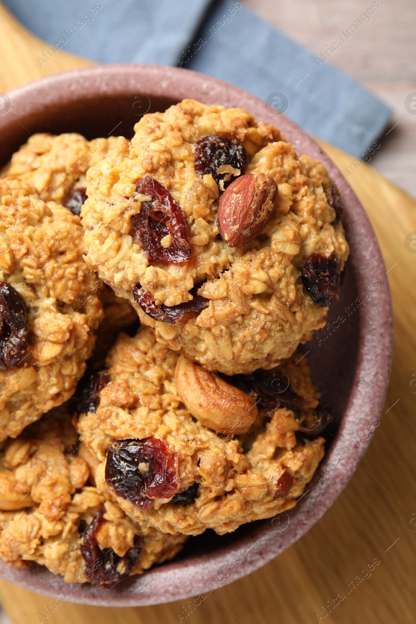 Photo of Delicious oatmeal cookies with raisins and nuts on table, top view