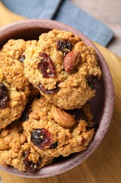 Photo of Delicious oatmeal cookies with raisins and nuts on table, top view