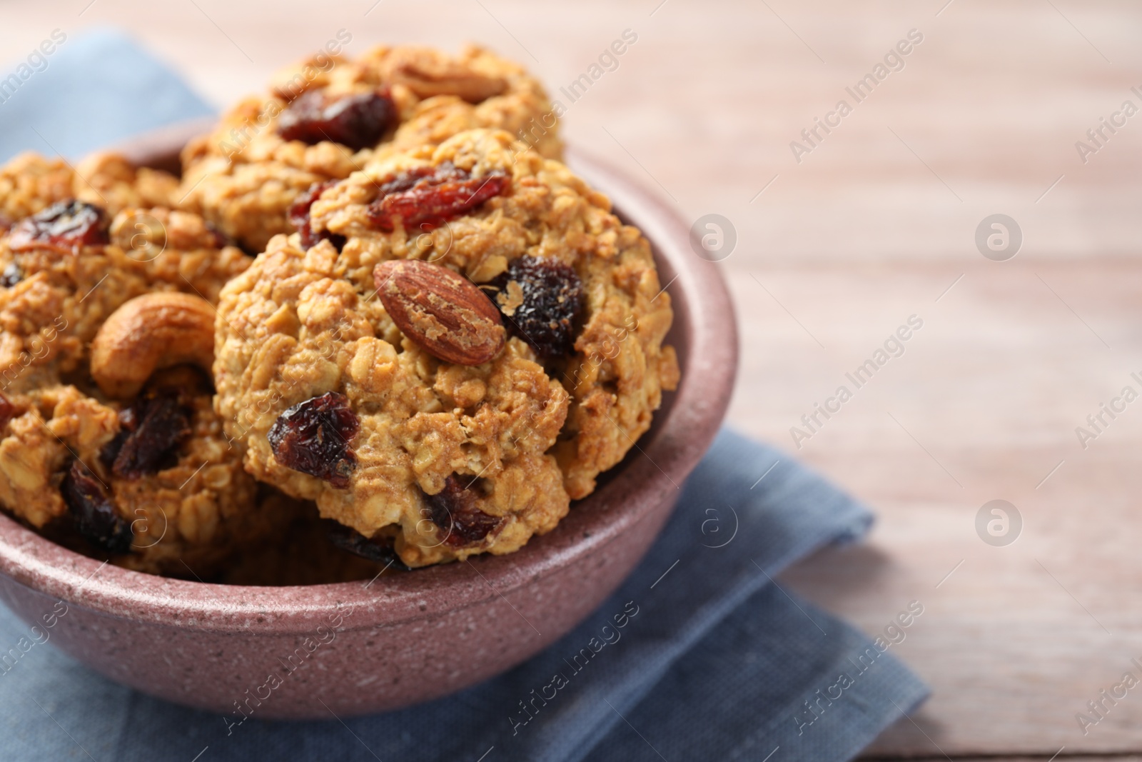 Photo of Delicious oatmeal cookies with raisins and nuts on table, closeup