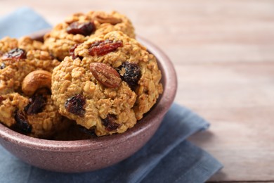 Photo of Delicious oatmeal cookies with raisins and nuts on table, closeup