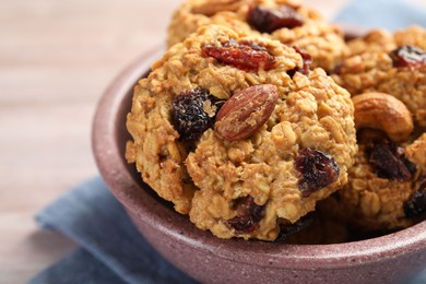 Photo of Delicious oatmeal cookies with raisins and nuts on table, closeup