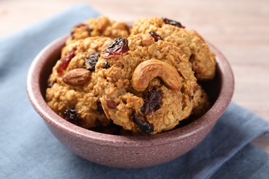 Photo of Delicious oatmeal cookies with raisins and nuts on table, closeup