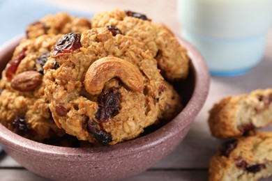 Photo of Delicious oatmeal cookies with raisins and nuts on table, closeup