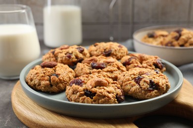 Photo of Delicious oatmeal cookies with raisins and nuts on table, closeup