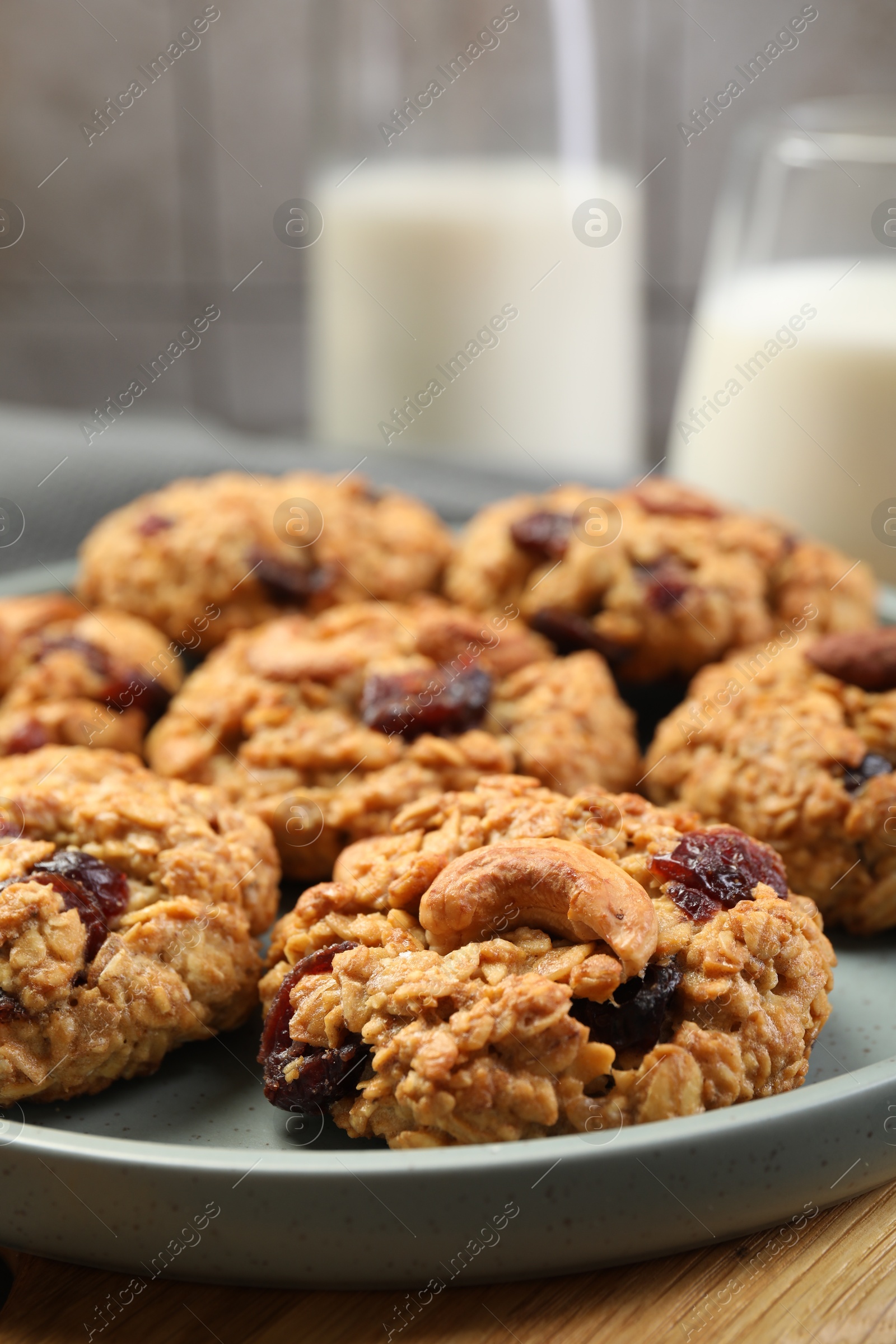 Photo of Delicious oatmeal cookies with raisins and nuts on table, closeup