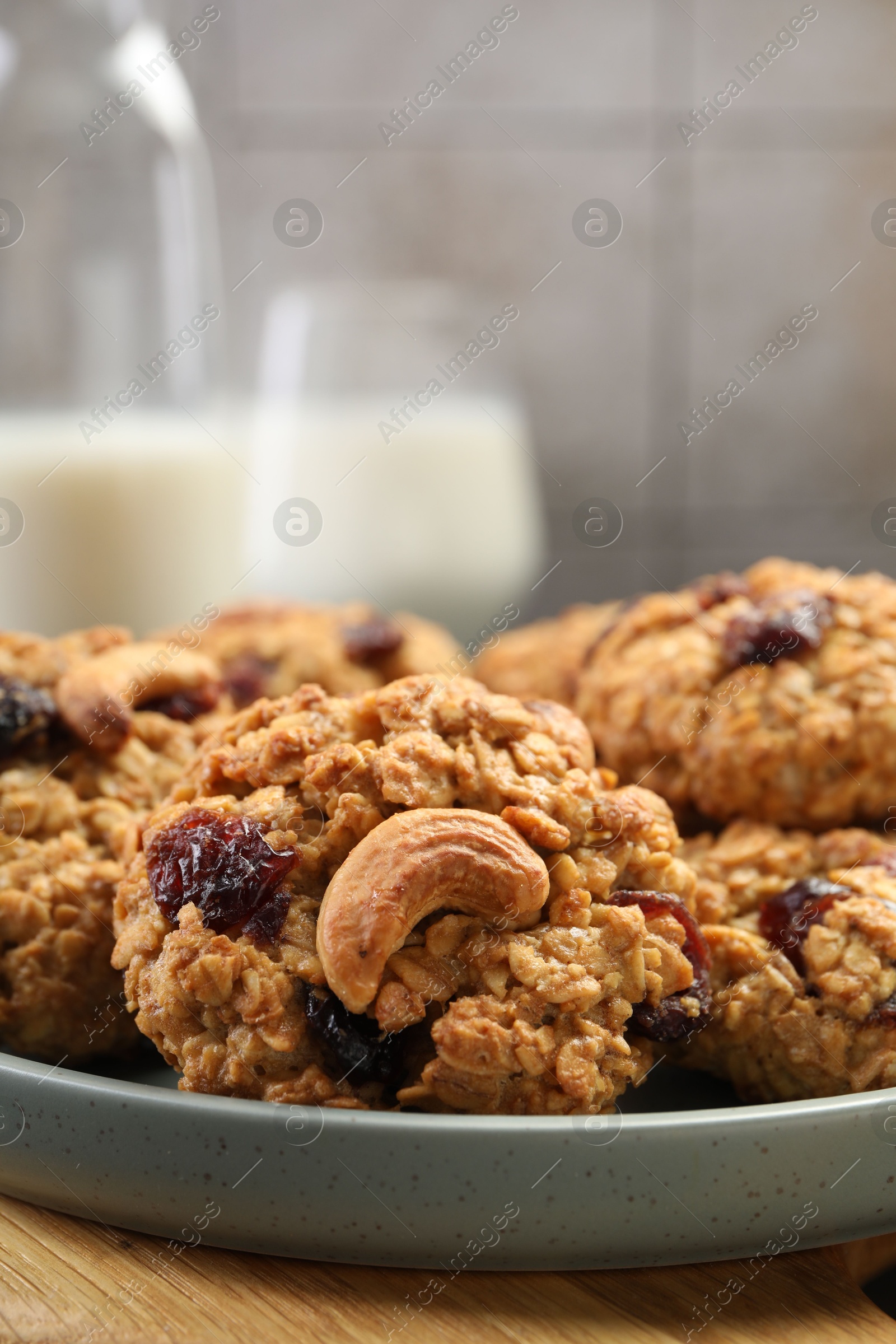 Photo of Delicious oatmeal cookies with raisins and nuts on table, closeup