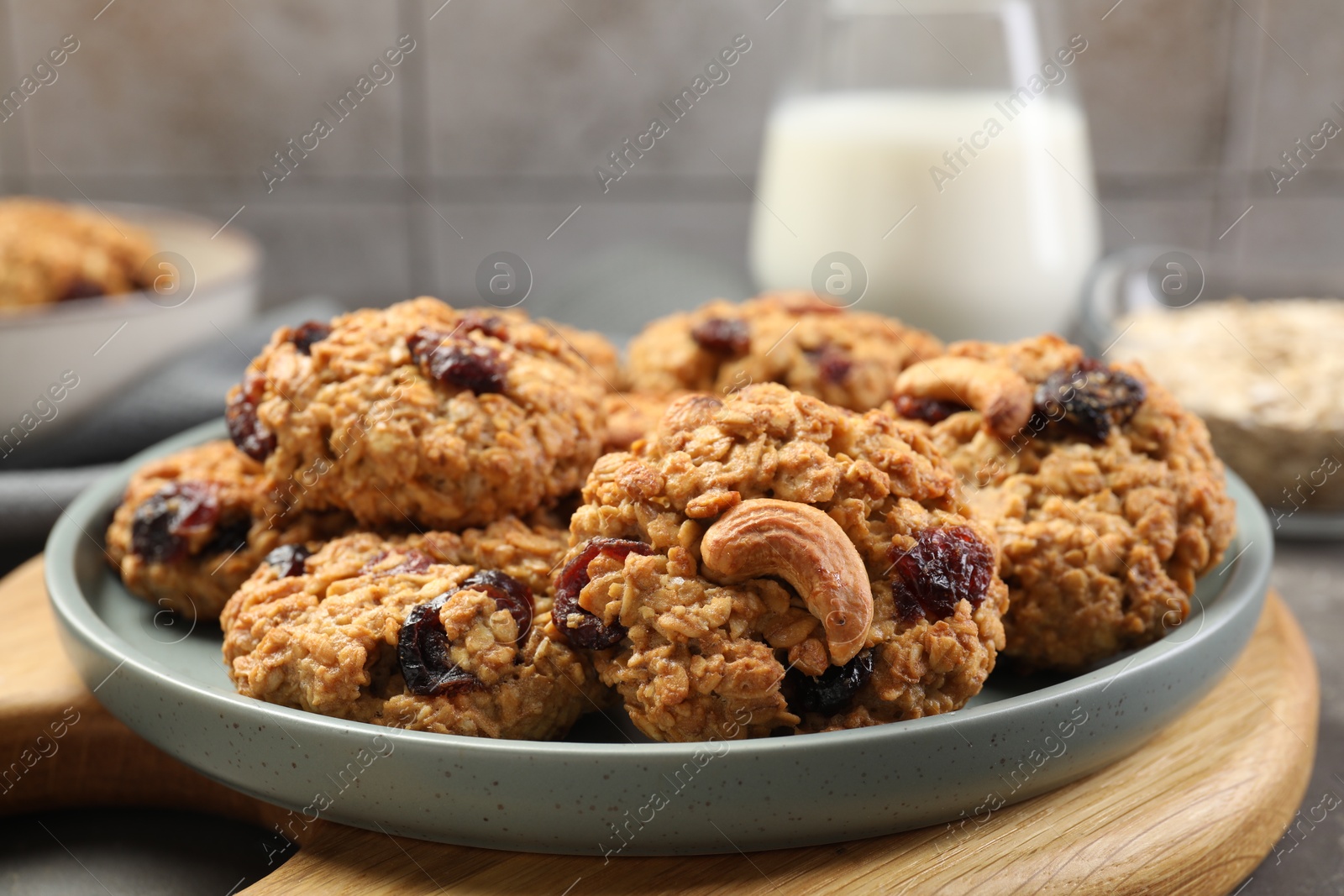 Photo of Delicious oatmeal cookies with raisins and nuts on table, closeup