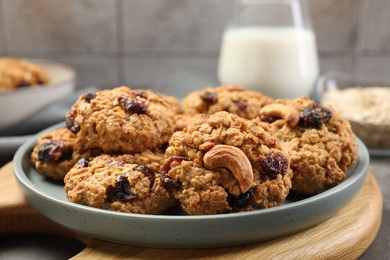 Photo of Delicious oatmeal cookies with raisins and nuts on table, closeup