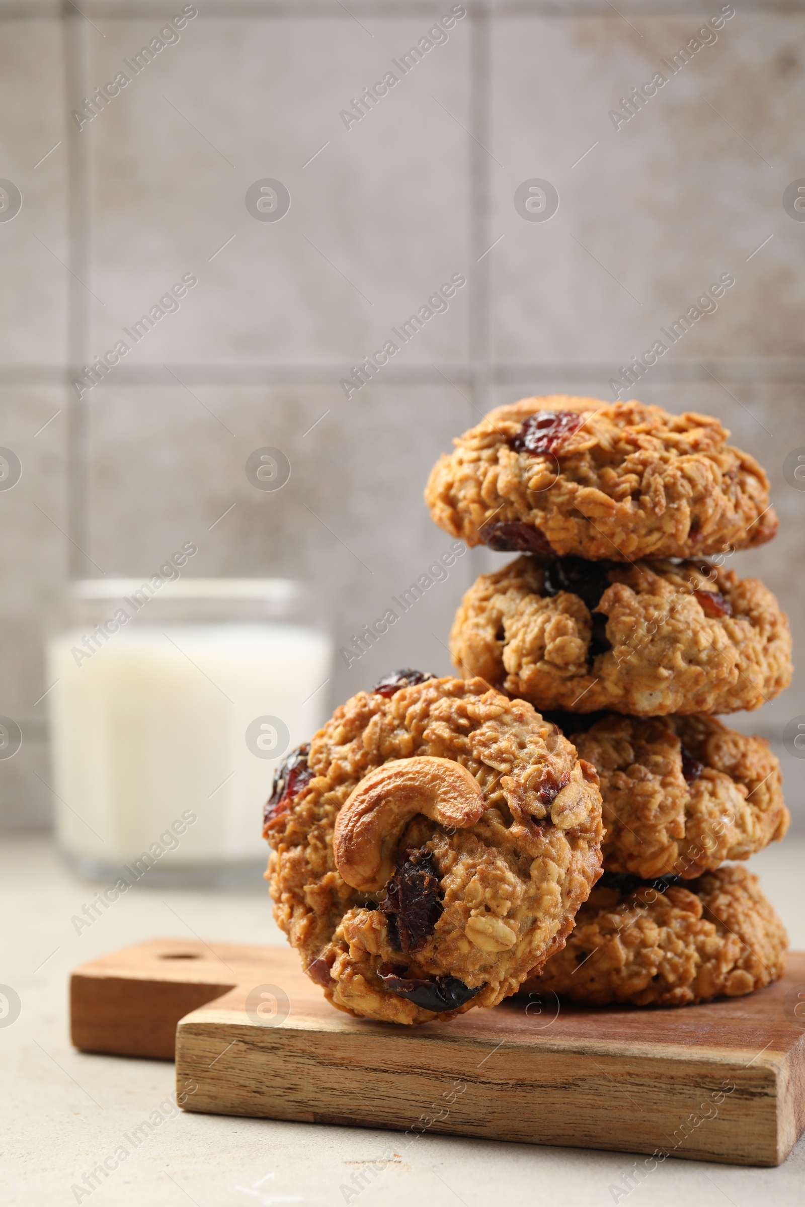 Photo of Delicious oatmeal cookies with raisins and nuts on light grey table