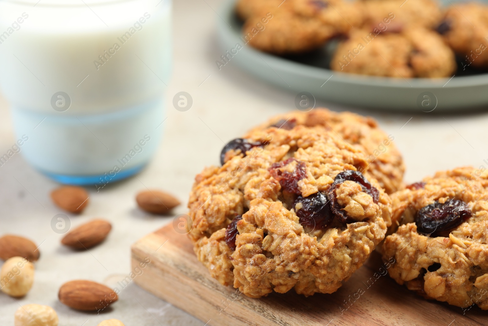 Photo of Delicious oatmeal cookies with raisins and nuts on table, closeup