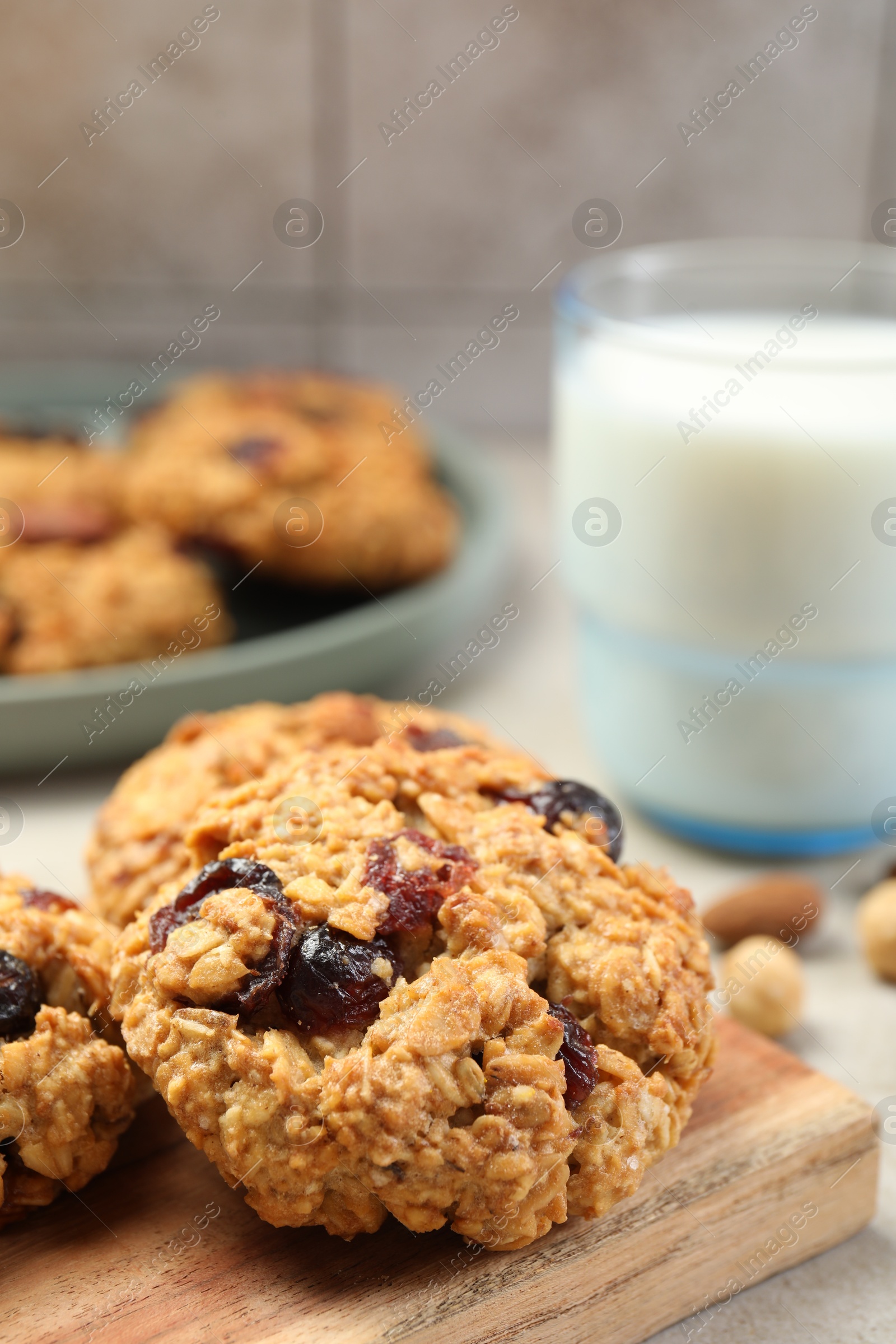 Photo of Delicious oatmeal cookies with raisins and nuts on table, closeup