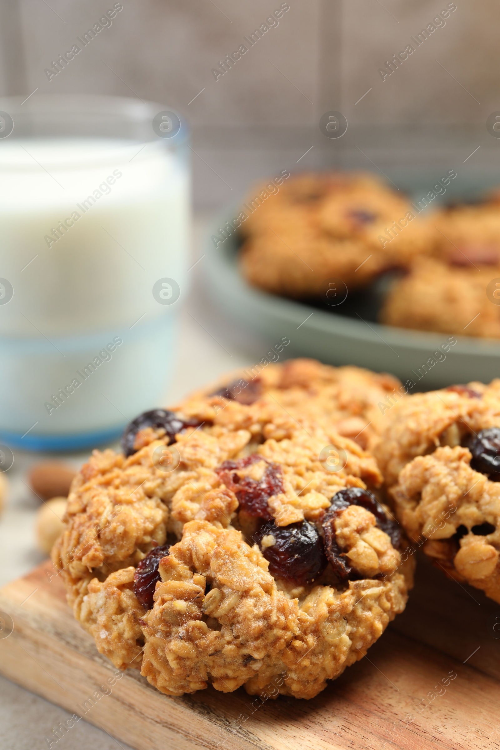 Photo of Delicious oatmeal cookies with raisins and nuts on table, closeup