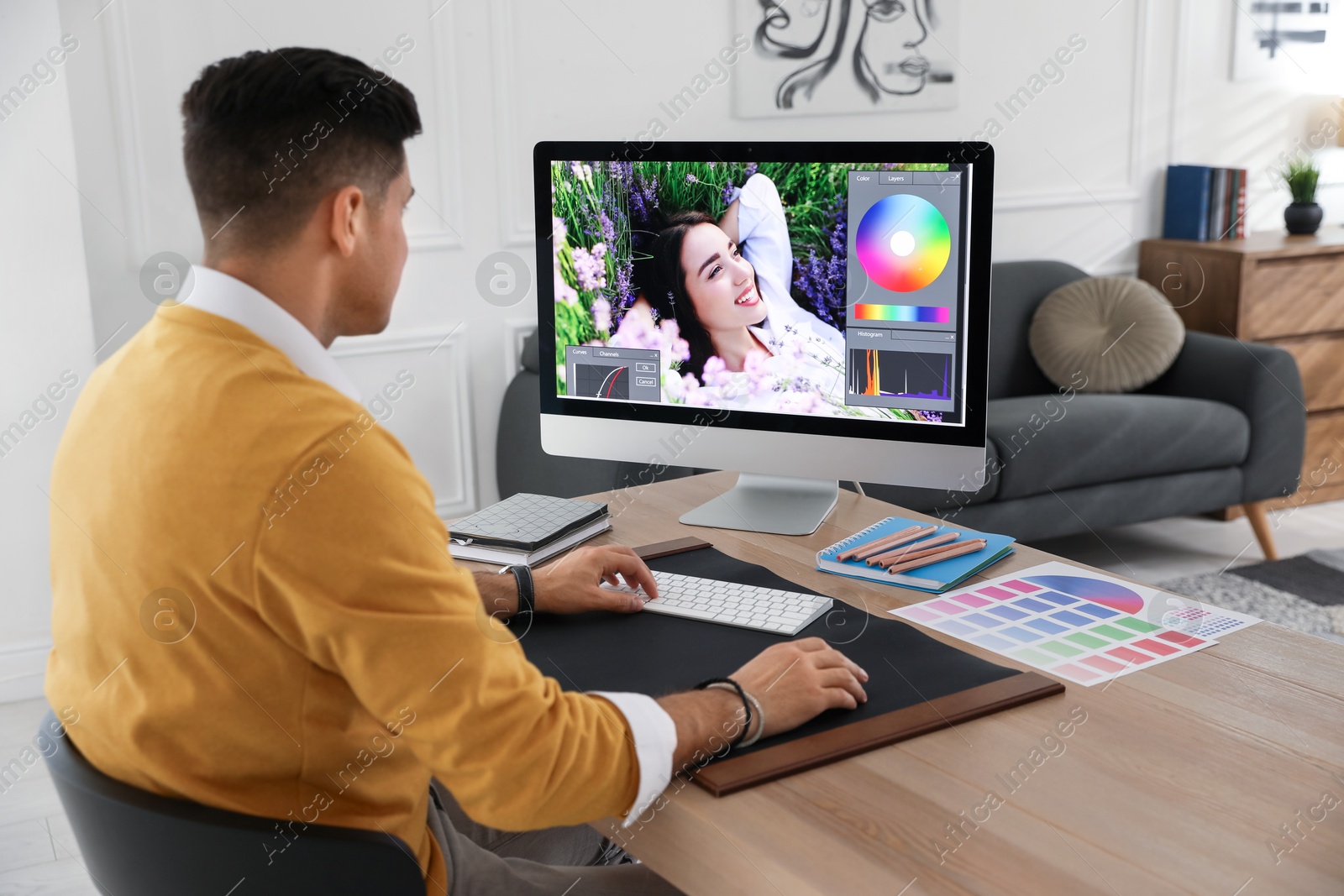 Photo of Professional retoucher working on computer in office