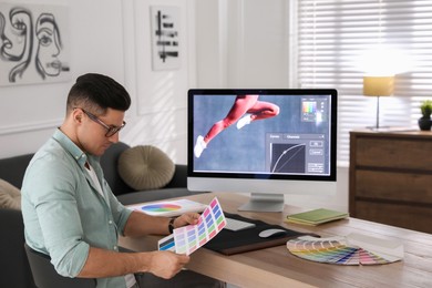 Professional retoucher working on computer in office