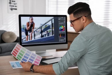 Professional retoucher working on computer in office