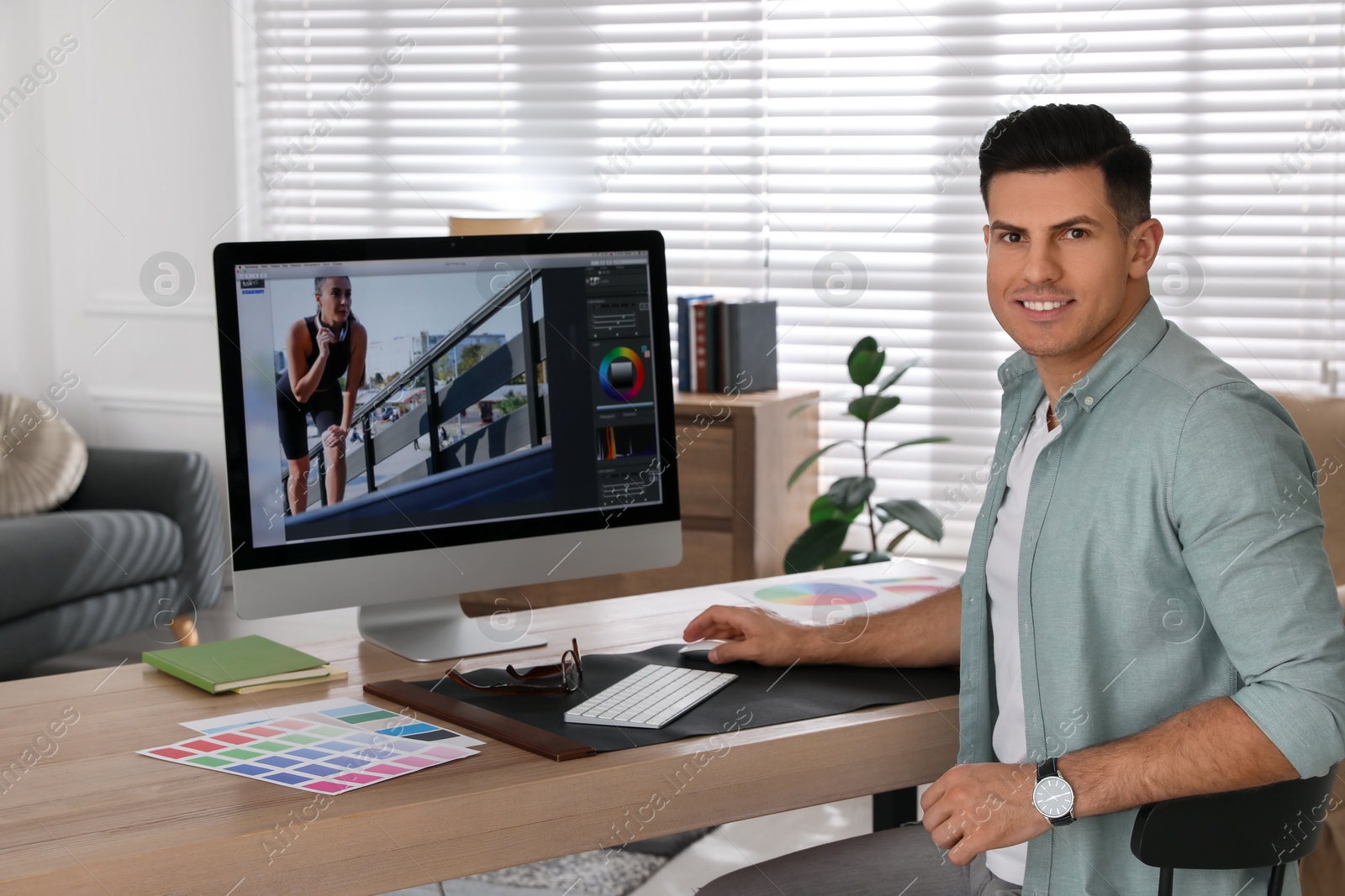 Photo of Professional retoucher working on computer in office