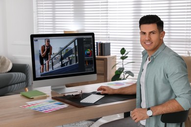 Photo of Professional retoucher working on computer in office