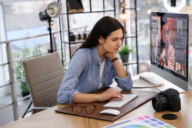 Photo of Professional retoucher working on computer in office