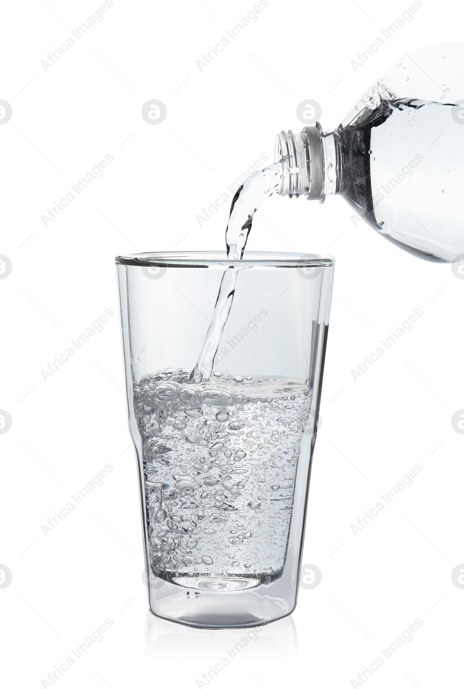 Photo of Pouring soda water from bottle into glass on white background