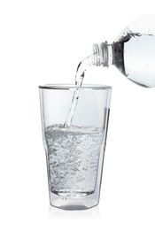 Photo of Pouring soda water from bottle into glass on white background