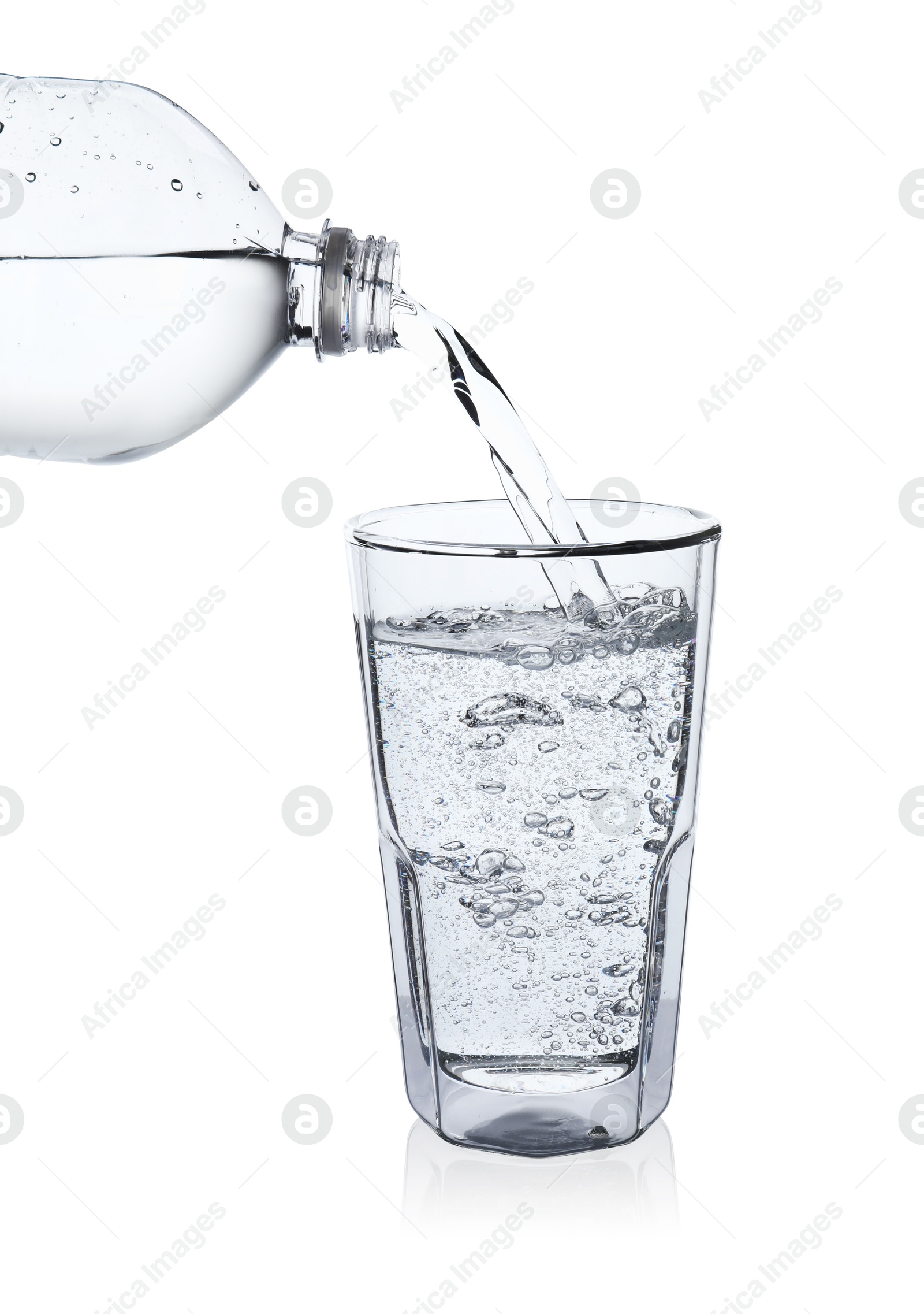 Photo of Pouring soda water from bottle into glass on white background