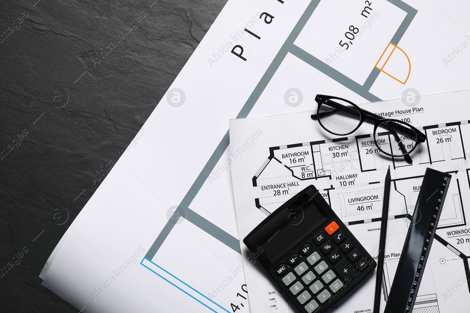 Photo of Different architectural drawings, glasses, calculator and ruler on grey textured table, flat lay