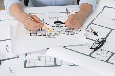 Photo of Architect working with project at table in office, closeup