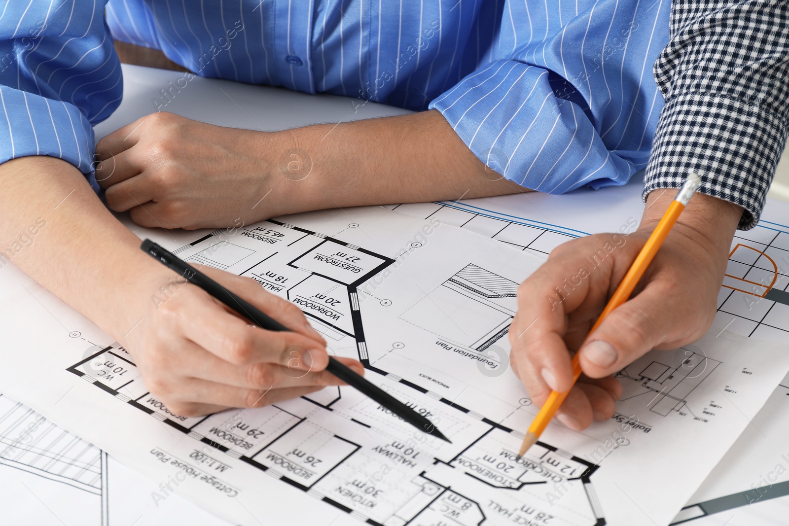 Photo of Architects working with project at table in office, closeup