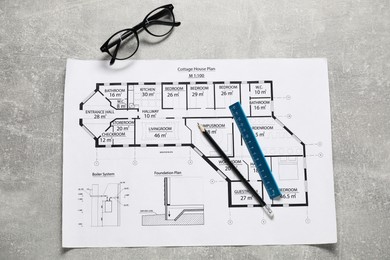 Photo of Different engineering drawings, glasses, pencil and ruler on grey textured table, flat lay