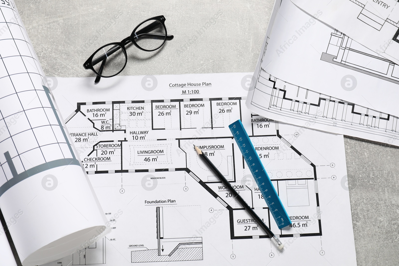 Photo of Different engineering drawings, glasses, pencil and ruler on grey textured table, flat lay