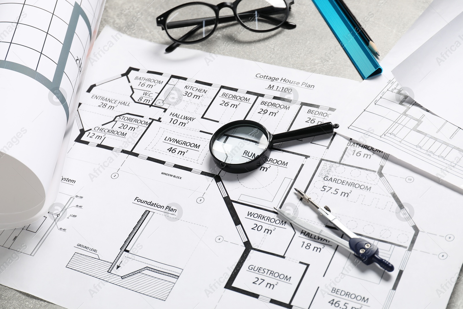 Photo of Different engineering drawings and tools on grey table