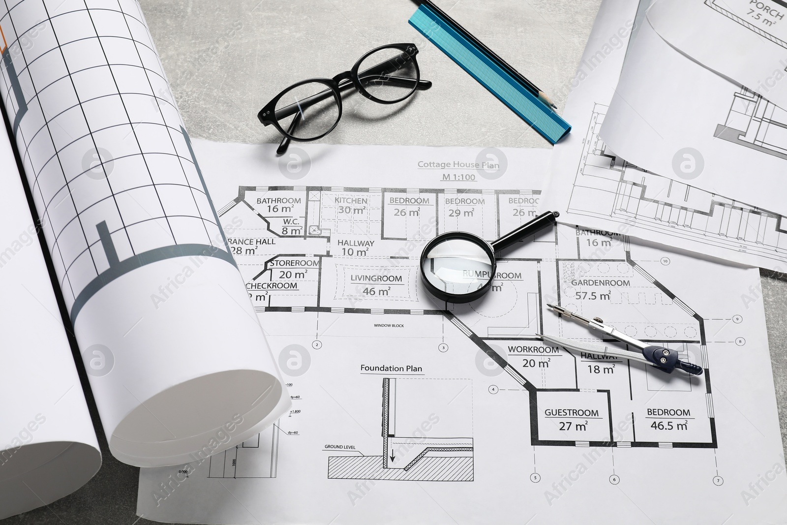 Photo of Different engineering drawings and tools on grey table, flat lay