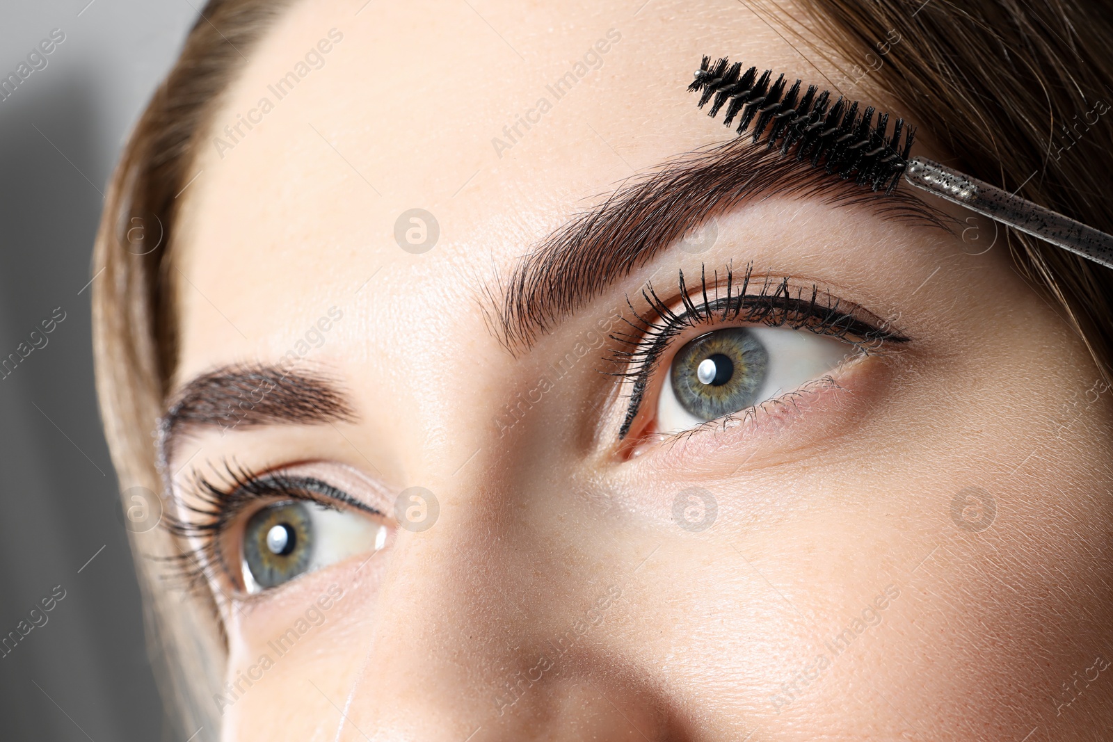 Photo of Beautiful young woman after henna eyebrows dyeing, closeup