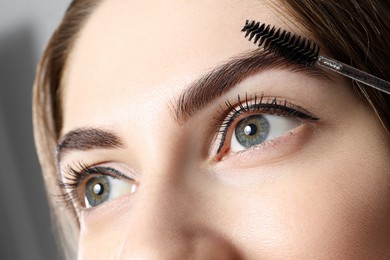 Photo of Beautiful young woman after henna eyebrows dyeing, closeup