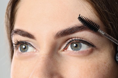 Photo of Beautiful young woman after henna eyebrows dyeing, closeup