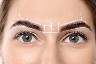 Photo of Young woman during henna eyebrows dyeing procedure, closeup