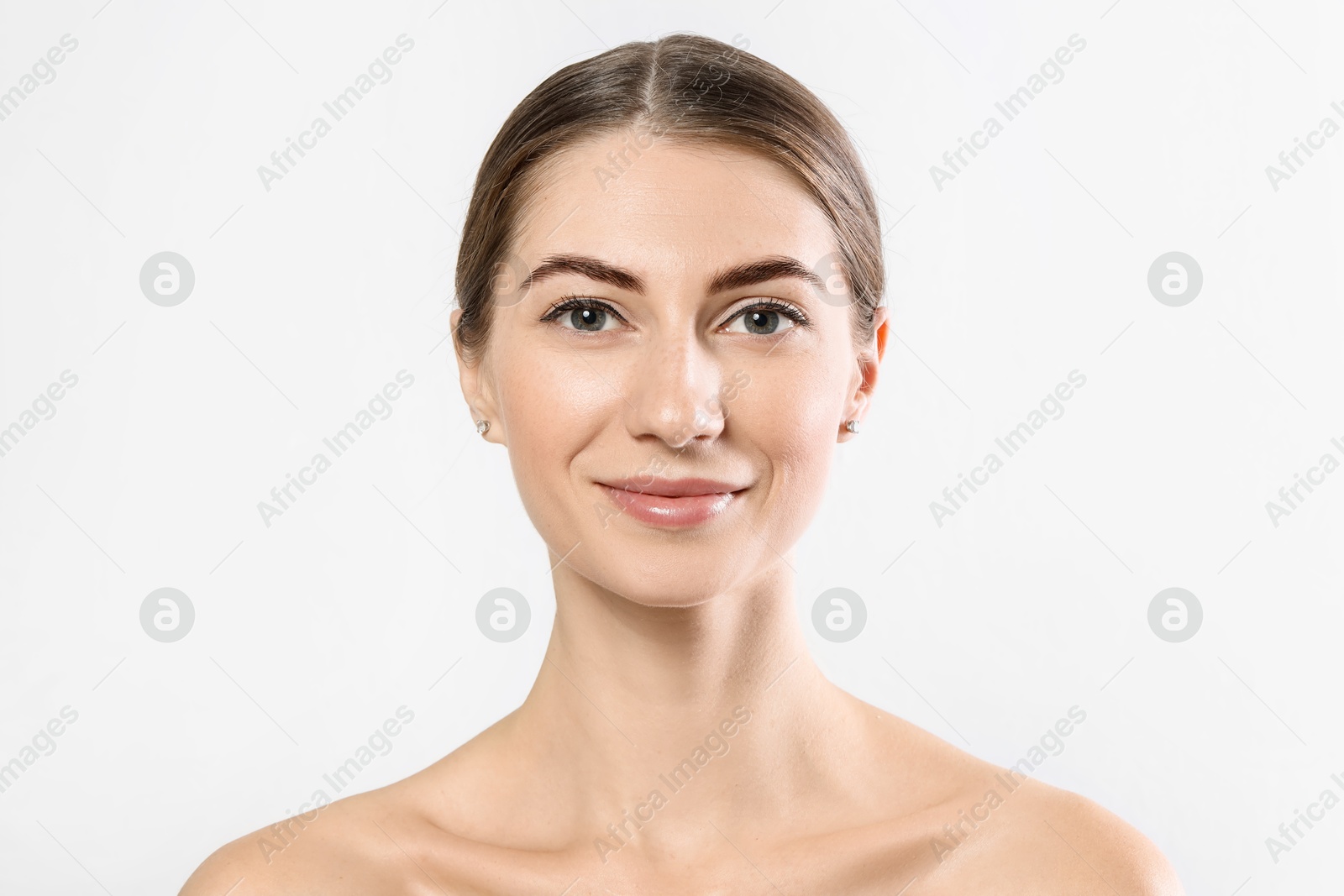 Photo of Beautiful young woman after henna eyebrows dyeing on light background, closeup