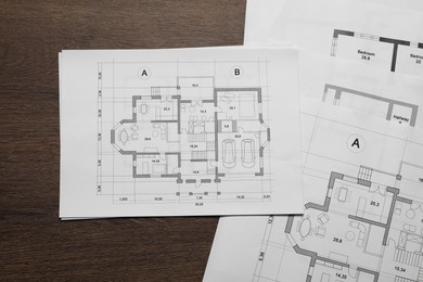 Photo of Different architectural drawings on wooden table, top view