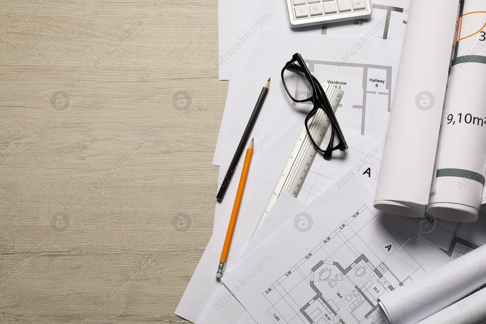 Photo of Different architectural drawings and tools on wooden table, top view. Space for text